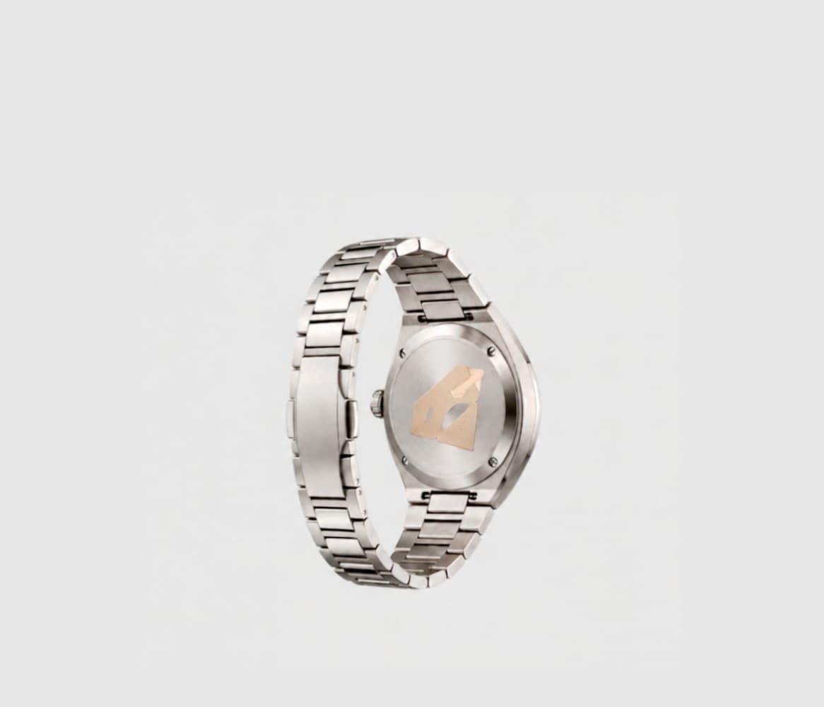 Steel watch on its side, the NFC chip visible on the case back